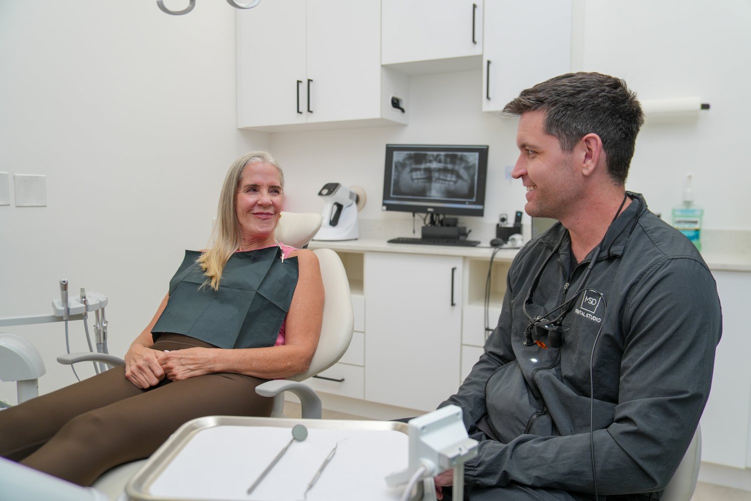 Dr. Matthew Dillon discussing tooth-replacement options with a patient at MSD Dental Studio, Coral Springs